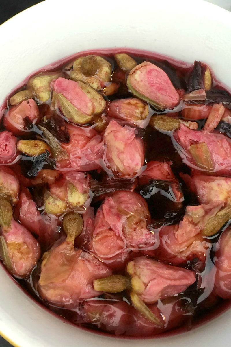 close-up photo of rosebuds and hibiscus steeping to make tea
