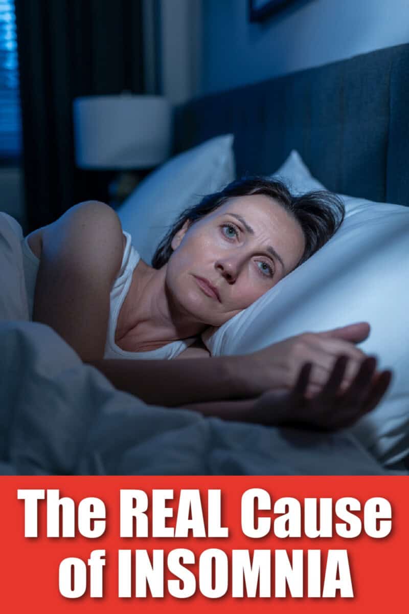 The real cause of insomnia text overlay on photo of woman lying awake in bed