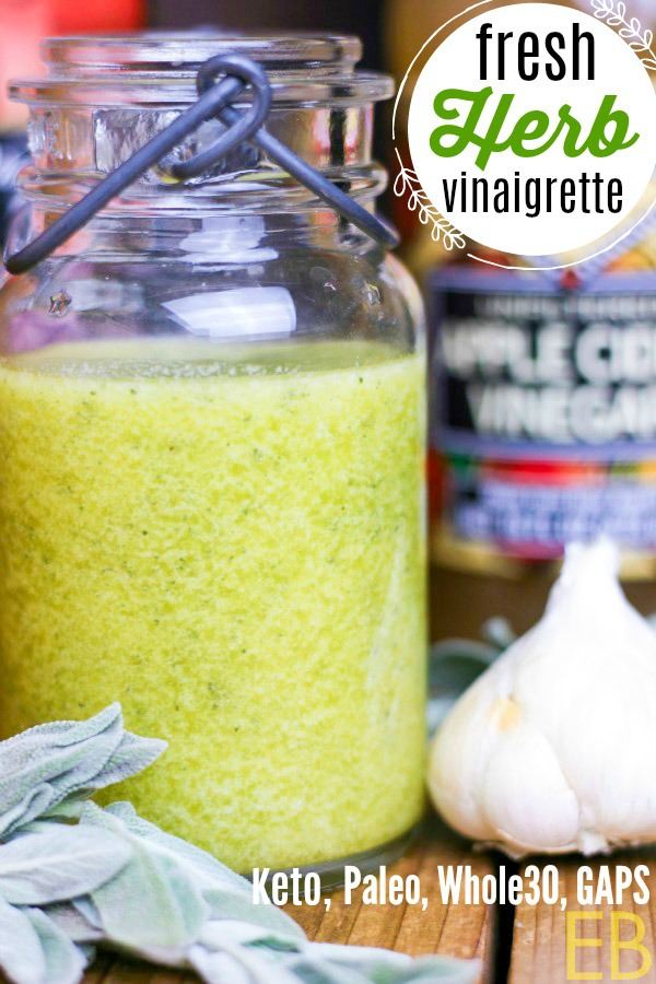bottle of green vinaigrette with garlic bulb to one side