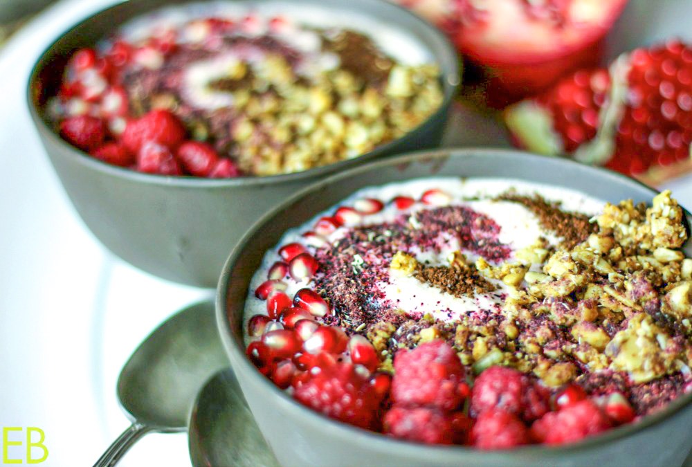 two bowls of pomegranate smoothie bowl