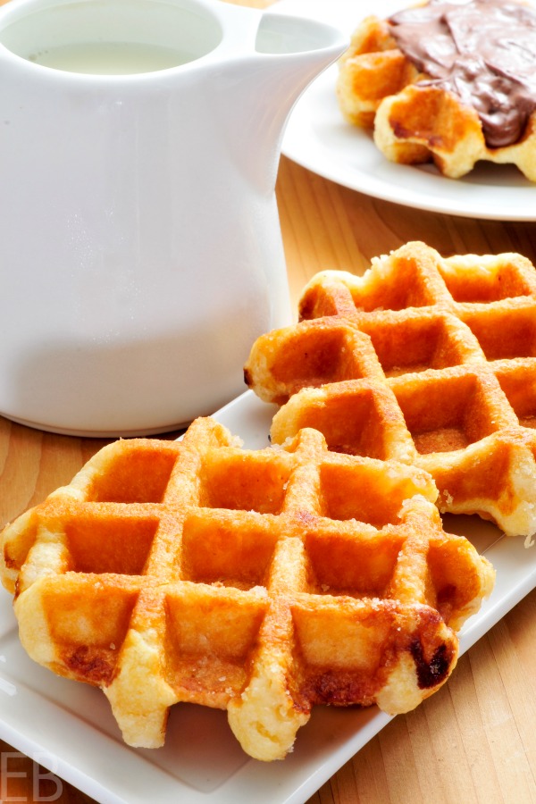 3 sourdough paleo cassava waffles with a jug of syrup and one with chocolate on top