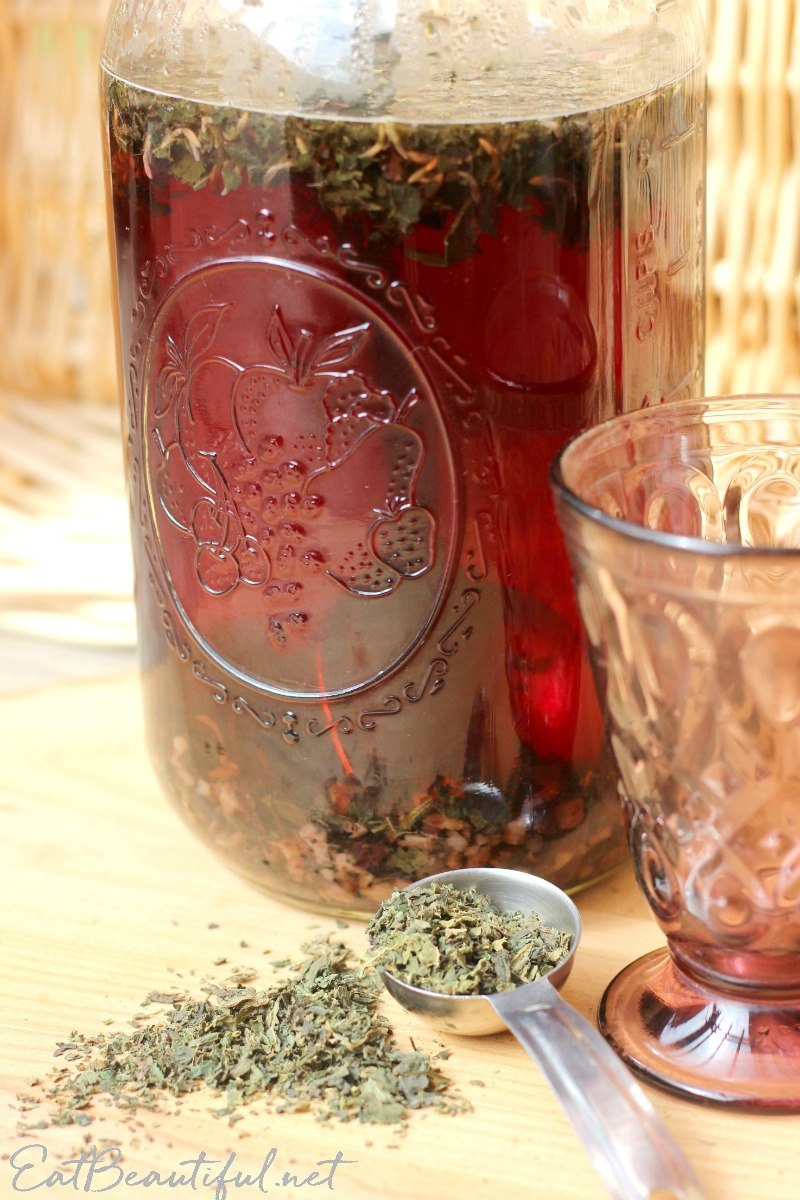 side view of dandelion and nettles detox tea in mason jar with glass