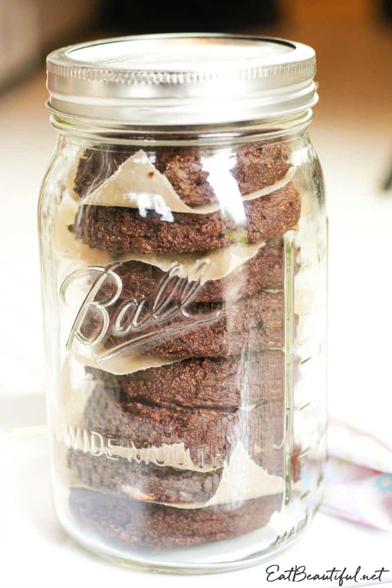 mason jar filled with stacked aip chocolate banana cookies for storage