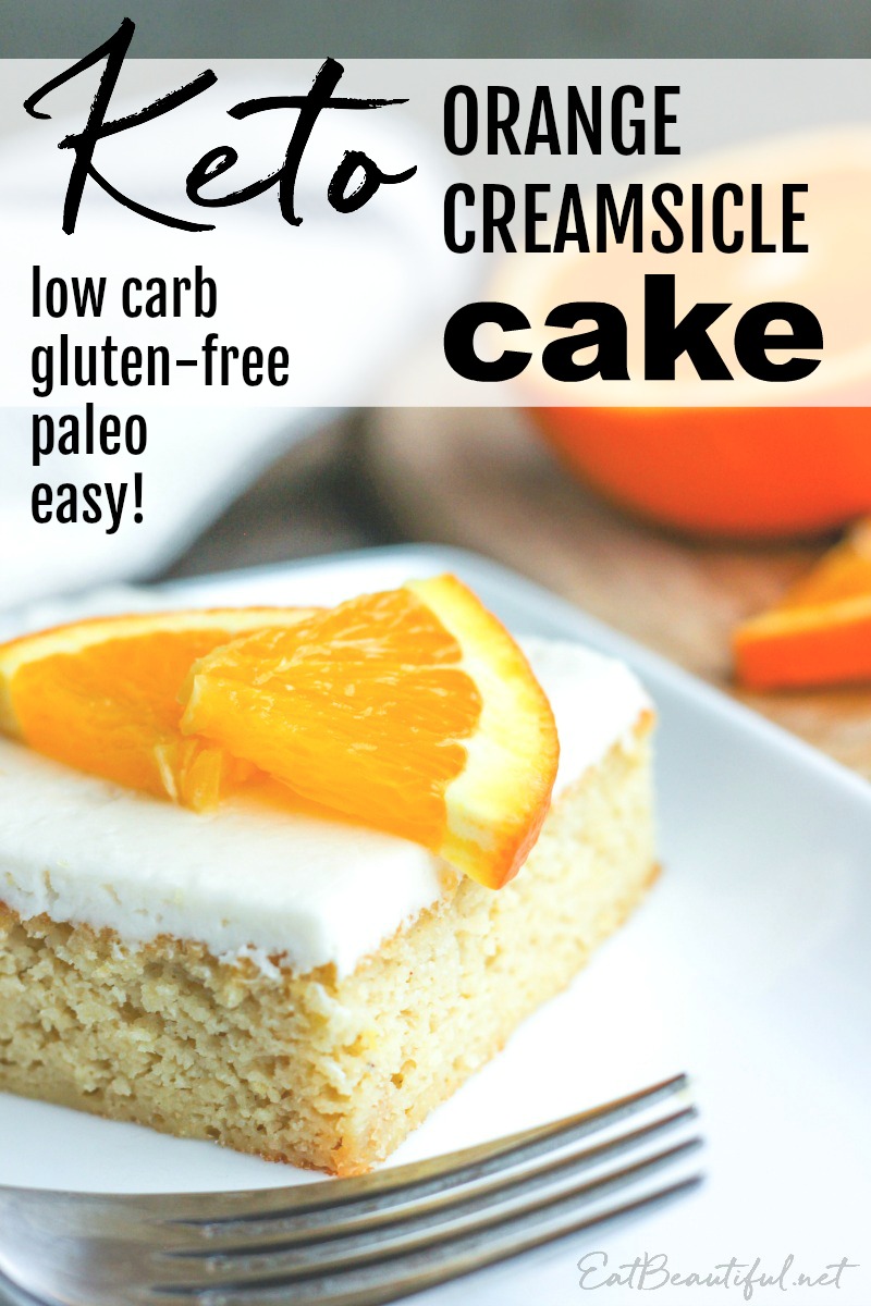 a slice of keto orange creamsicle cake with fork and orange slices