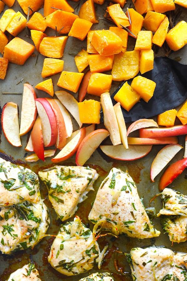 overhead view of chicken, apples and squash sheet pan dinner on pan