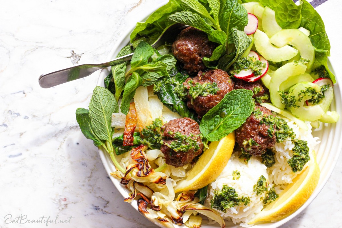 overhead view of asian meatballs bowl with lettuce and salad