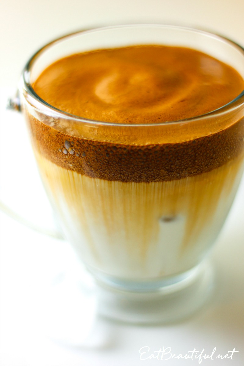 side view of dalgona mushroom coffee in clear coffee mug