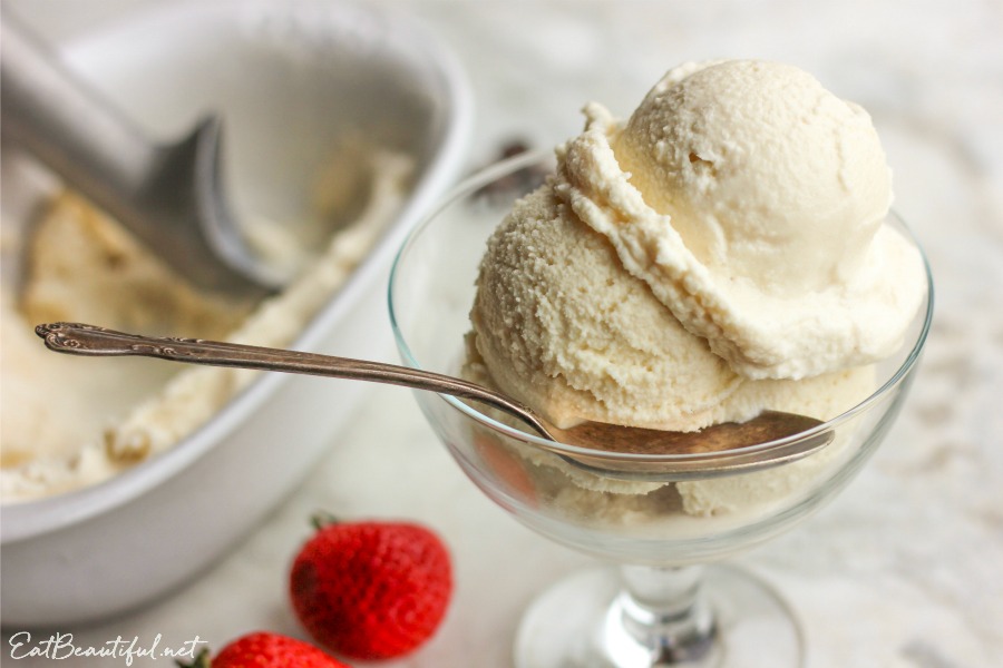 side view of several scoops of paleo vanilla ice cream in dish with spoon