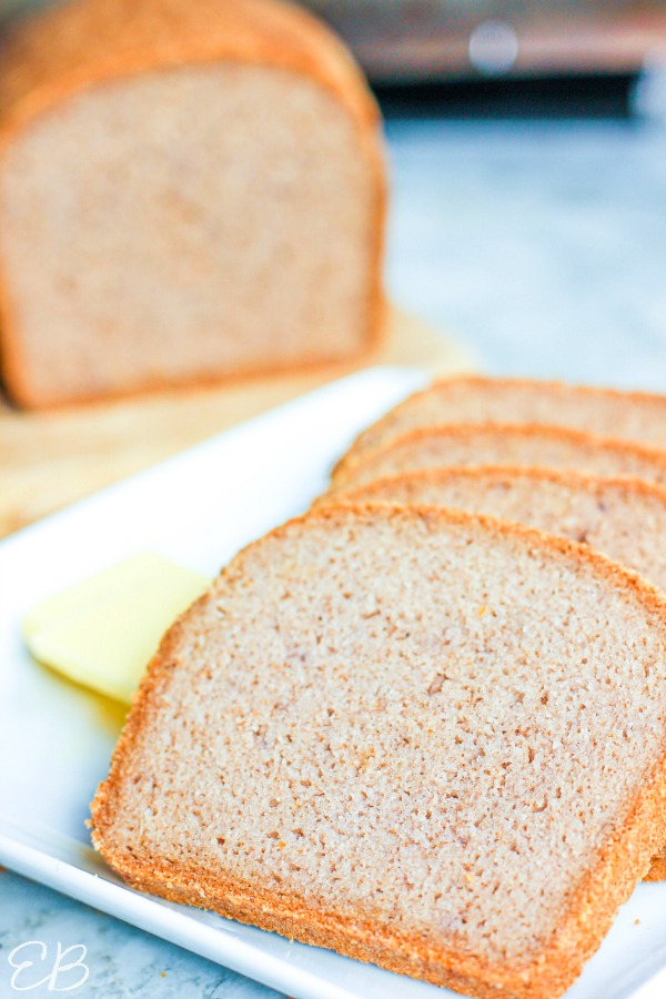 slices of gf rice bread in the foreground and the loaf in the background