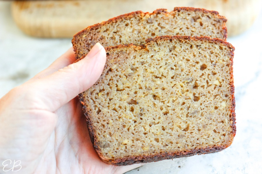 a hand holding two slices of aip sourdough bread