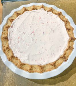pie filled with strawberry cream pie mixture