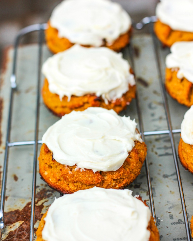 close-up view of three frosting aip pumpkin cookies