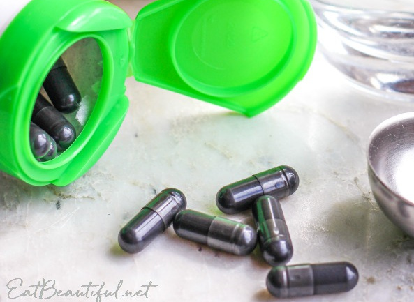 several activated charcoal pills and the container