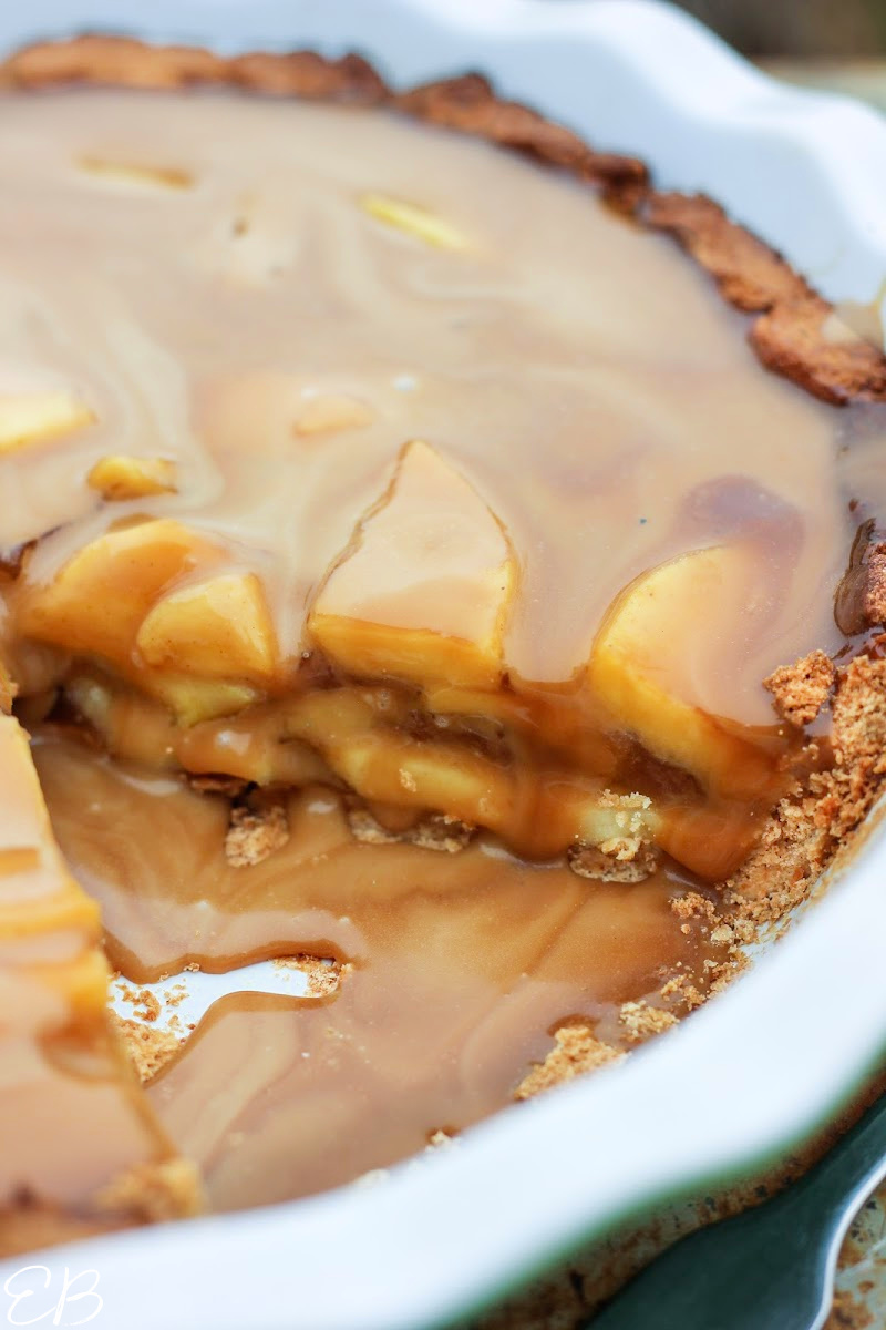 a slice cut out of aip caramel apple pie