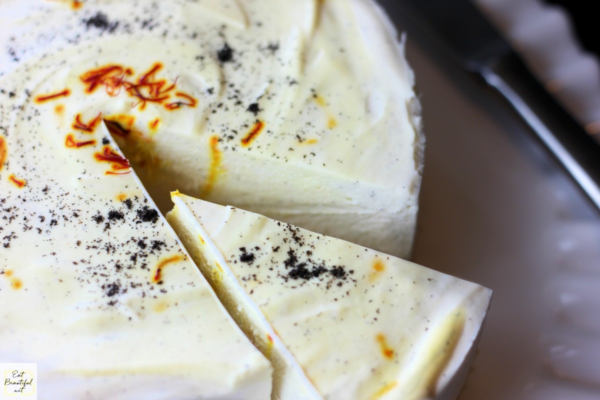 one slice being served from saffron vanilla cheesecake
