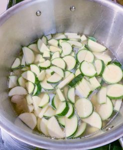 zucchini in broth in saucepan process photo