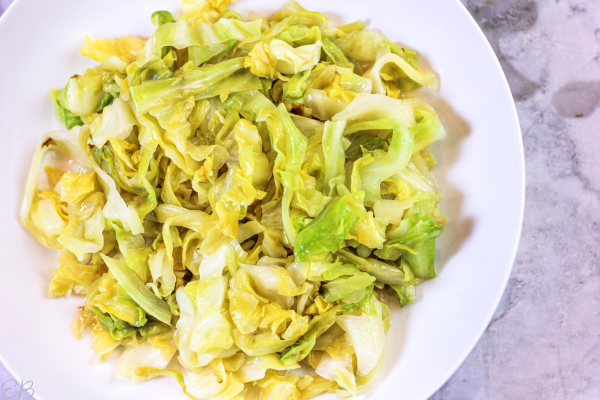 overhead view of braised cabbage noodles in white bowl