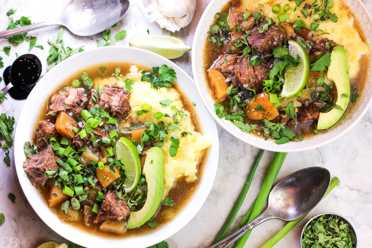 overhead view of low histamine bowls of stew with toppings around the sides of the bowls