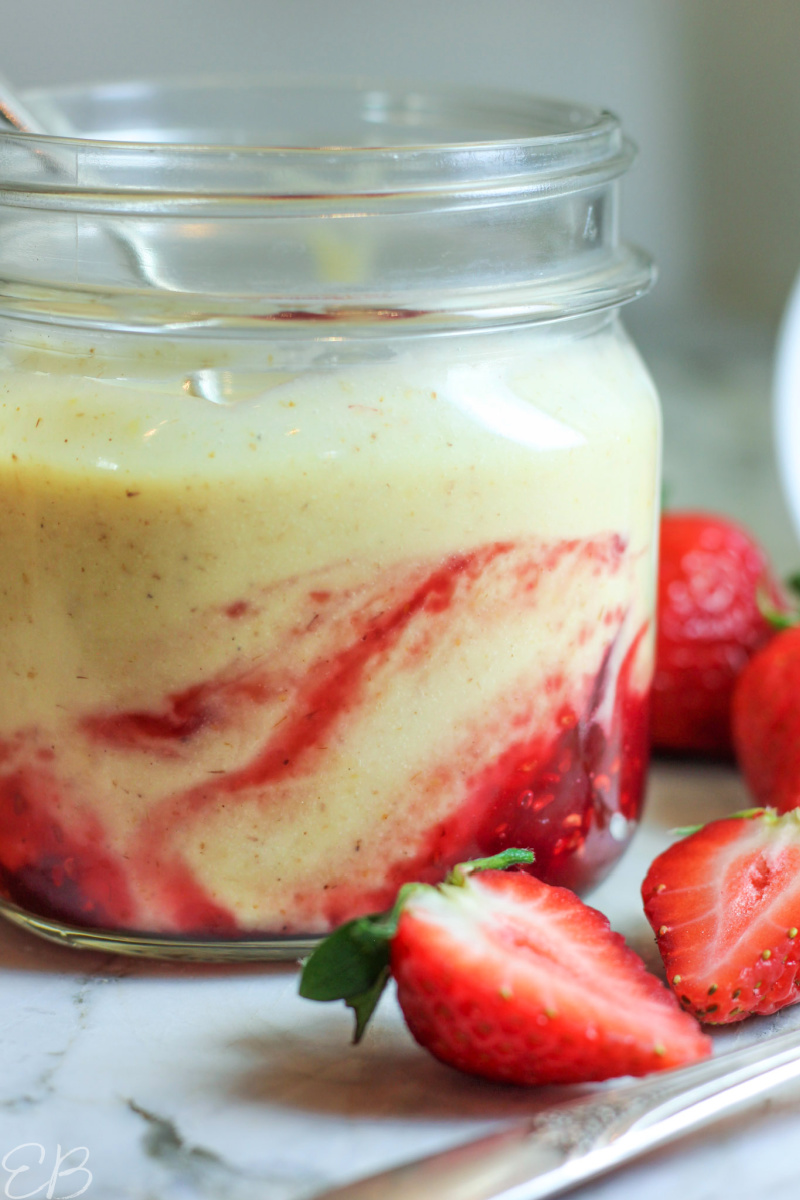 side view of raspberry jam swirled into yogurt