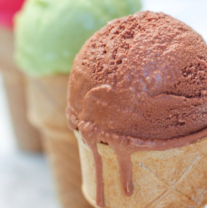 3 cones of avocado ice cream with the chocolate flavor in the front