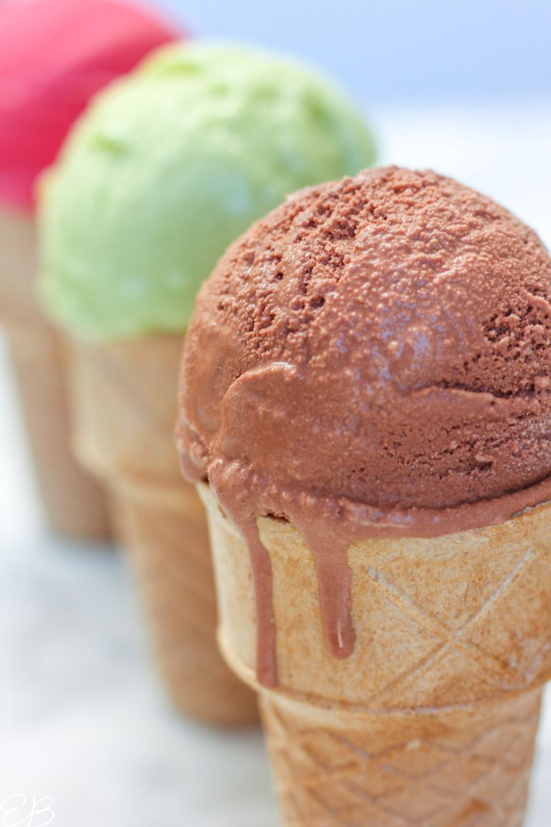 3 cones of avocado ice cream with the chocolate flavor in the front