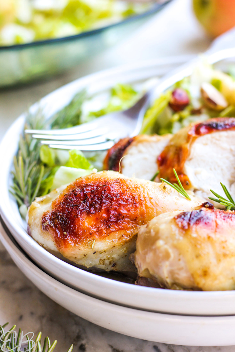 side view of plate served with salad and maple rosemary chicken