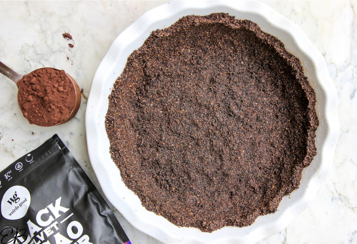 overhead view of black velvet cacao powder and oreo pie crust