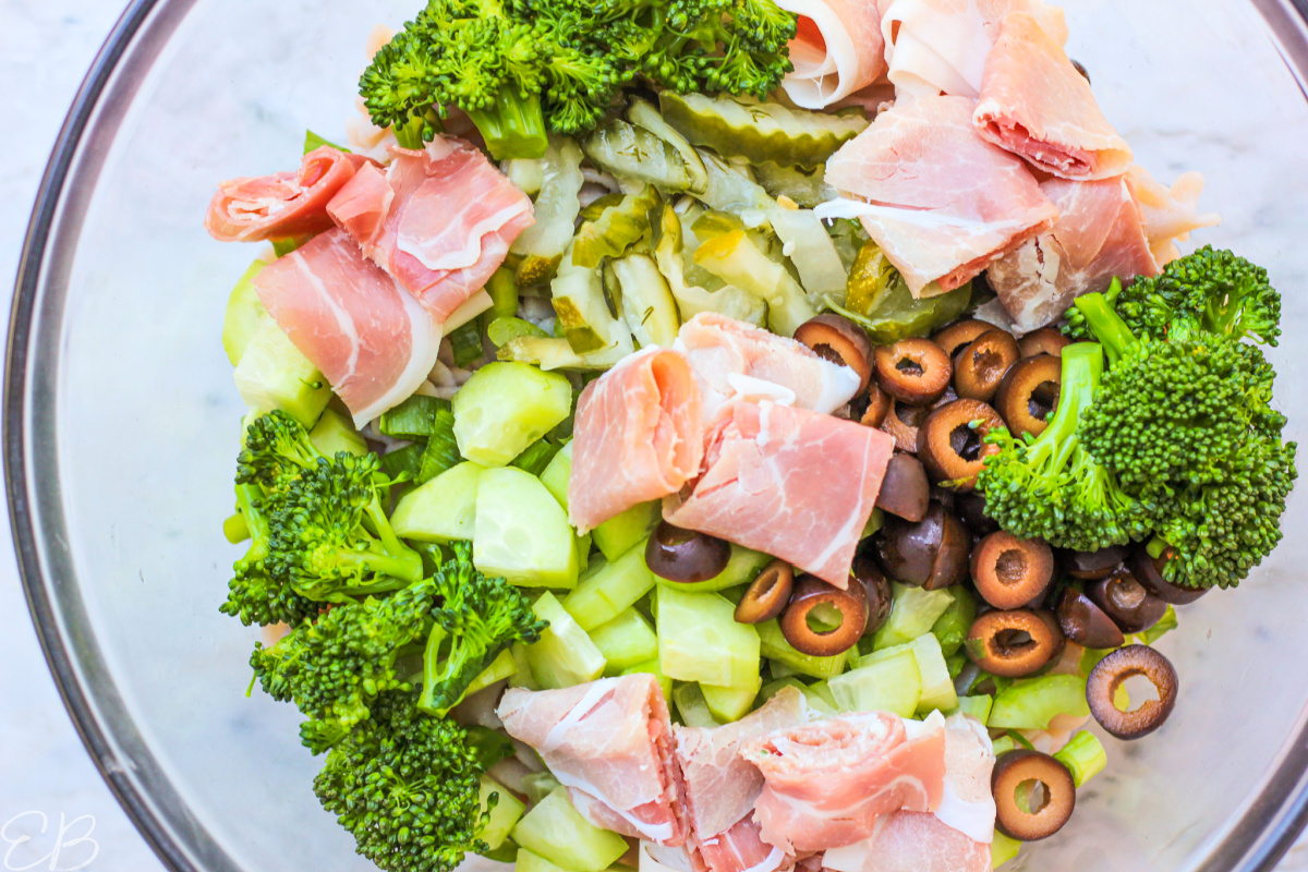 aerial view of paleo & aip antipasto pasta salad ingredients in glass bowl