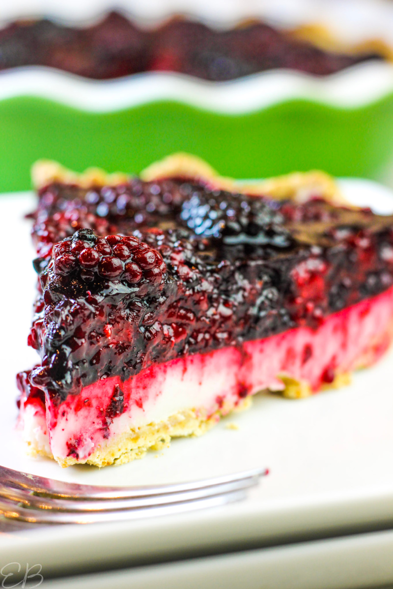 an up close photo of one slice served of blackberry lemon cream pie