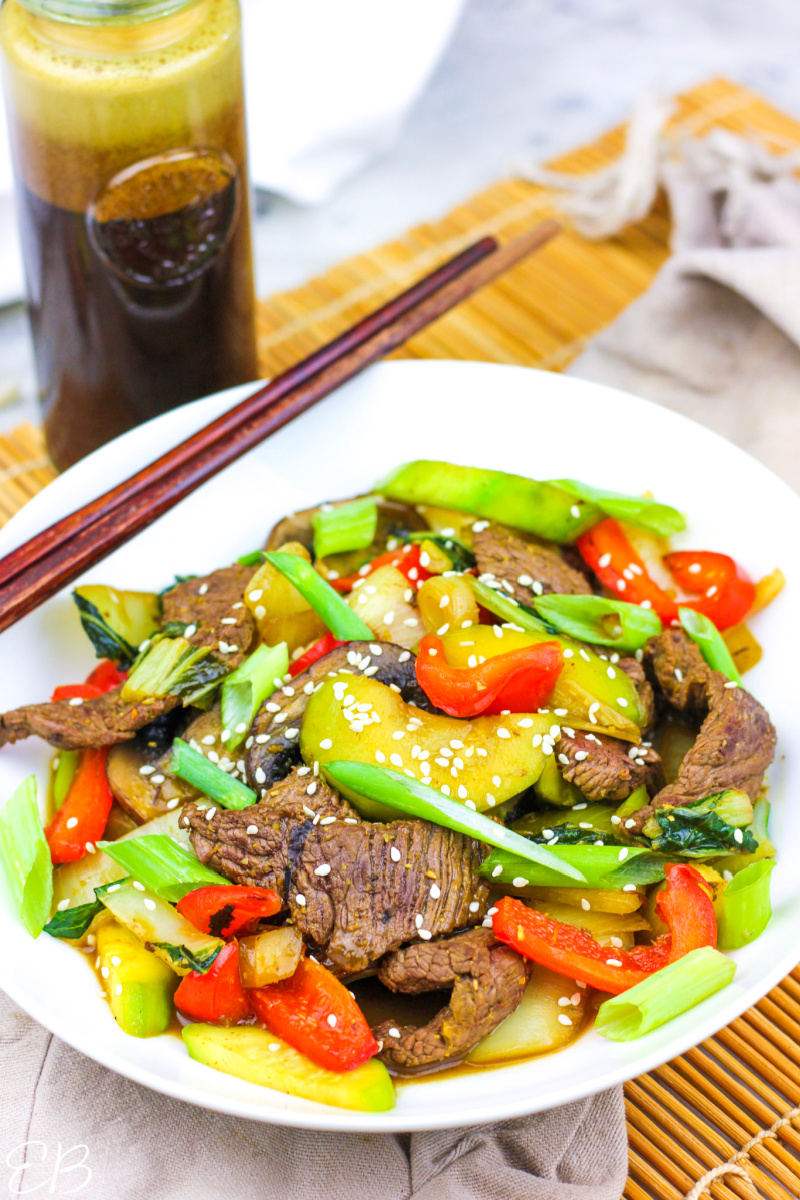 a steak stir fry with teriyaki sauce in the background