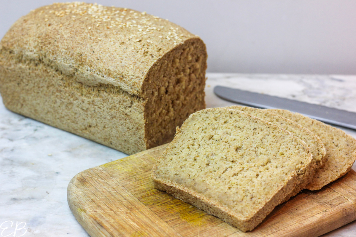 whole loaf of gluten-free vegan oat bread with 3 slices cut off