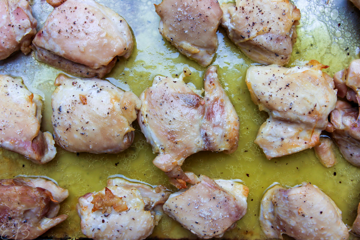 close up view of meal prep sheet pan chicken thighs after being baked