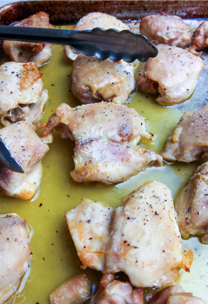 side angle view of baked chicken thighs on sheet pan