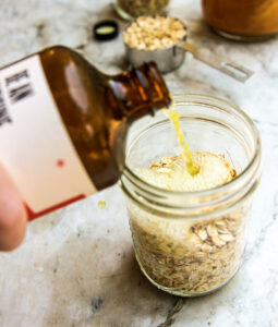 pouring kombucha into oats process photo