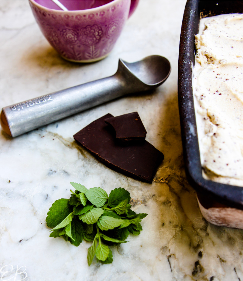 dark chocolate bar and fresh mint next to ice cream