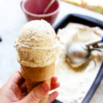 holding a cone of paleo mint chocolate chip ice cream