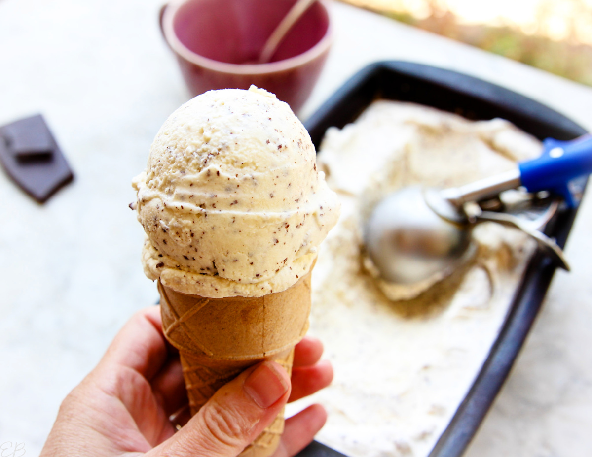 holding a cone of paleo mint chocolate chip ice cream