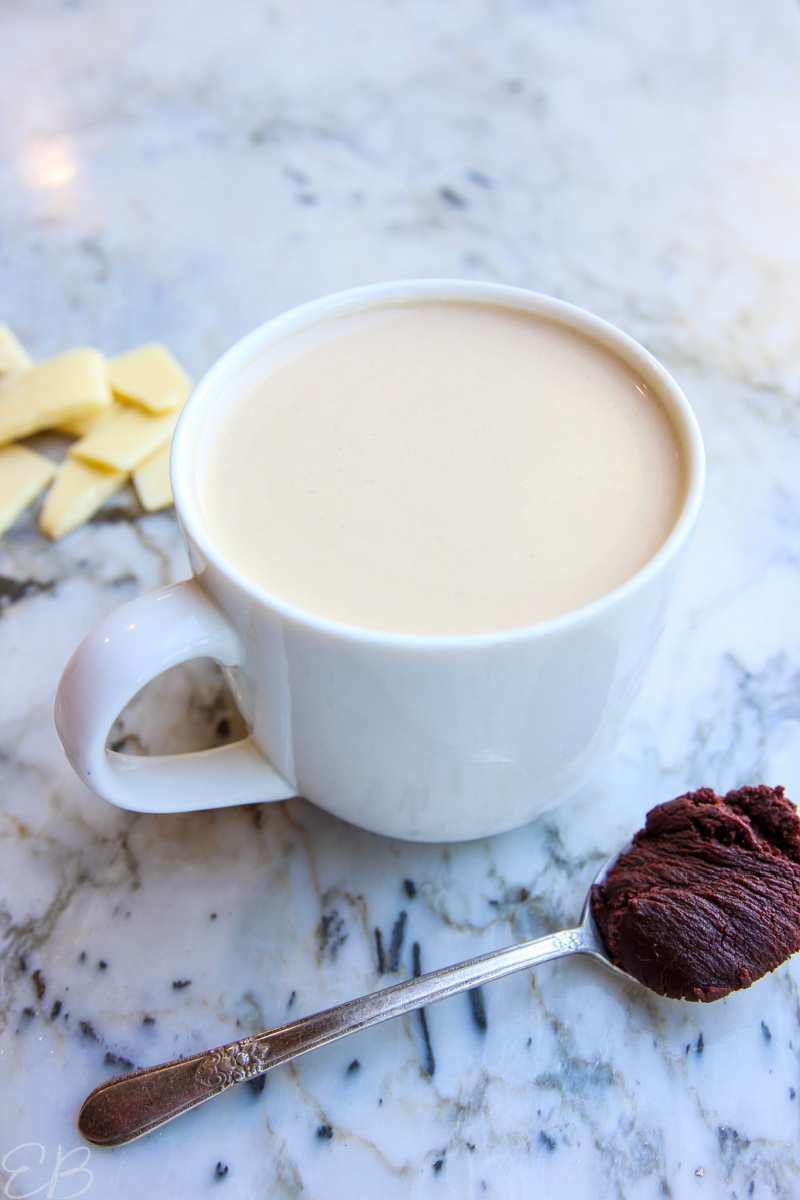 a white mug filled with cocoa butter bulletproof coffee