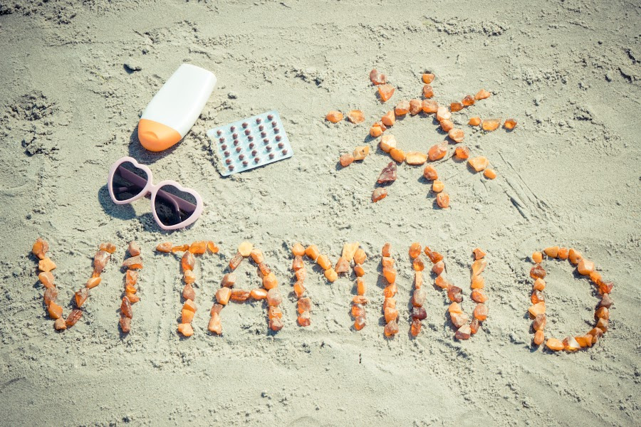 Vitamin D written in rocks on the sand