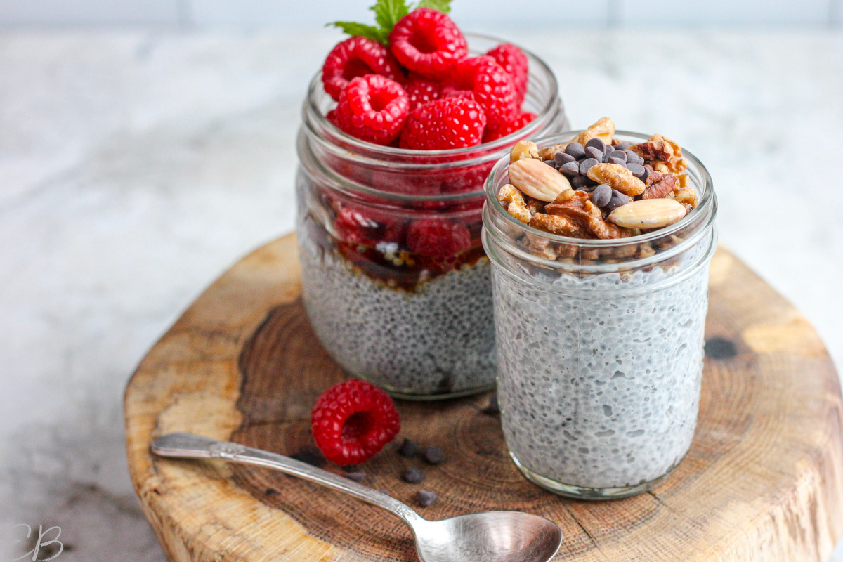 2 jars of basil seed pudding on small wooden block