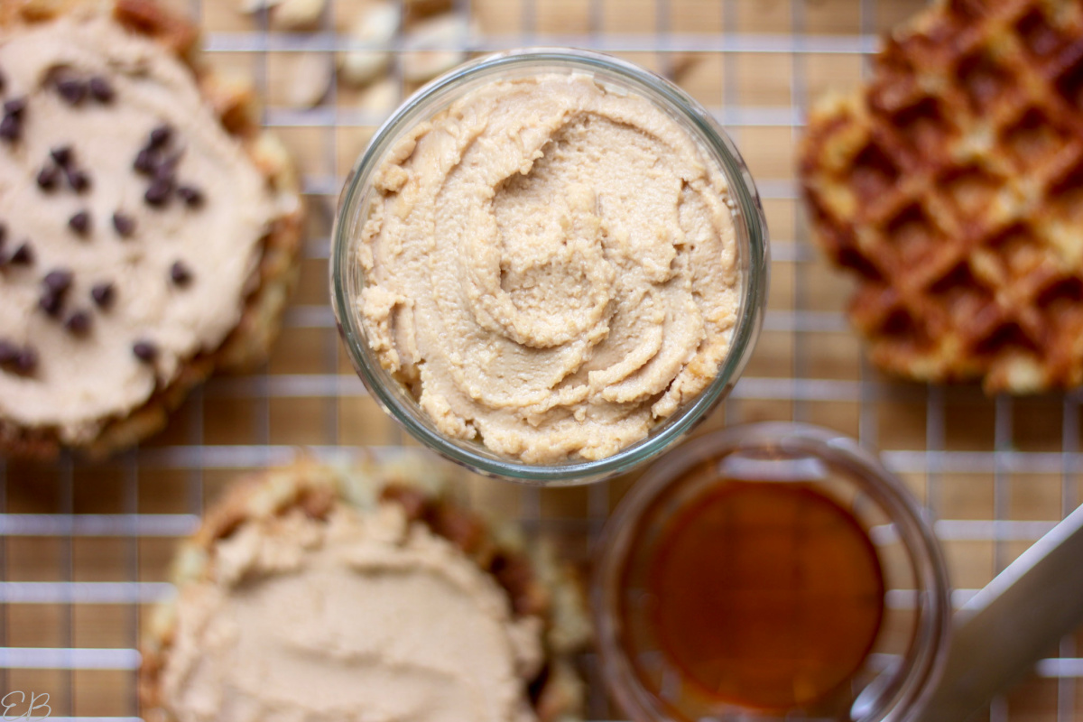 a jar of fermented peanut butter surrounded by waffles with peanut butter