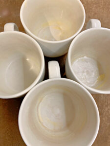 4 greased white mugs