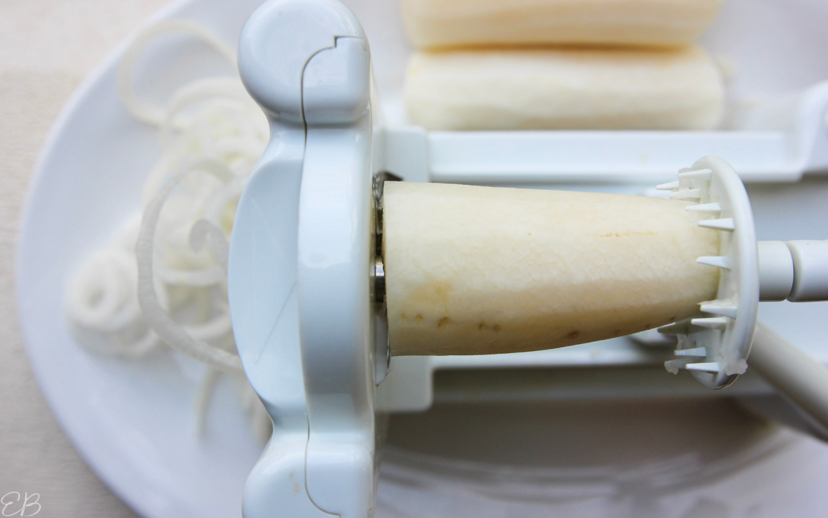 overhead view of daikon in spiralizer making noodles