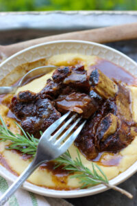 easiest paleo beef short ribs served on polenta with pan juices