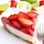 one slice of strawberry coconut lime cream pie on white plate