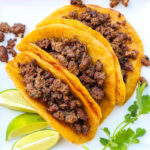 3 plantain taco shells filled with meat