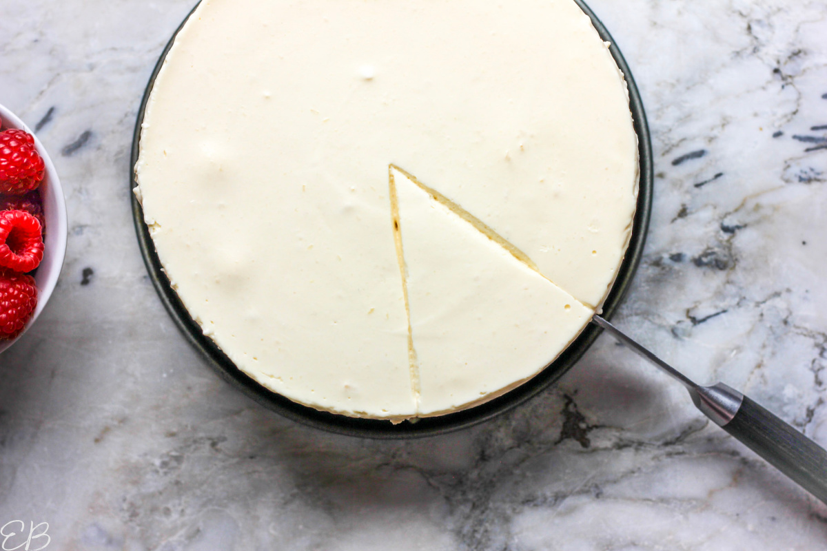 overhead view of cutting into yogurt cheescake