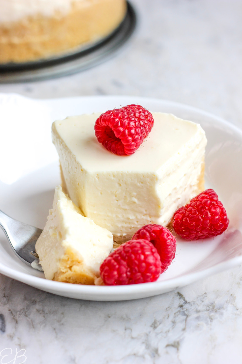 close-up photo of yogurt cheesecake with fork and first bite sliced off