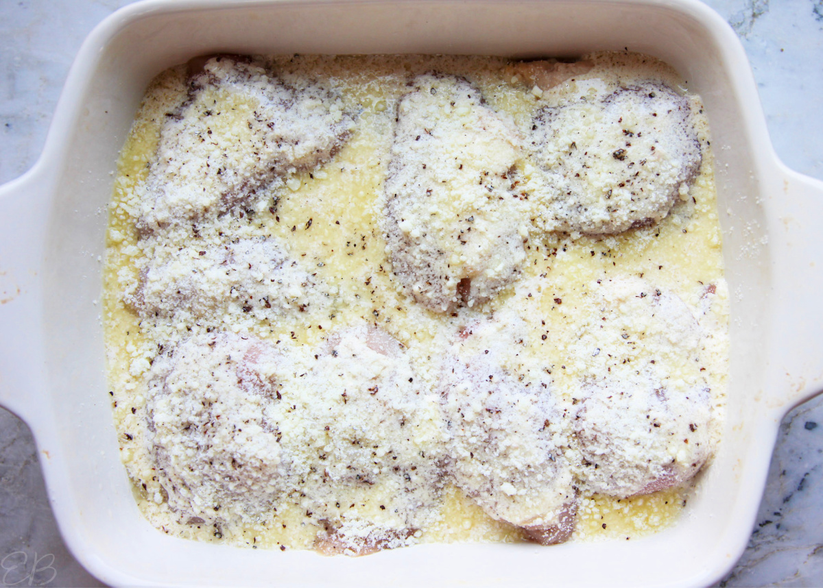 process photo of caesar sauce poured over chicken in baking dish