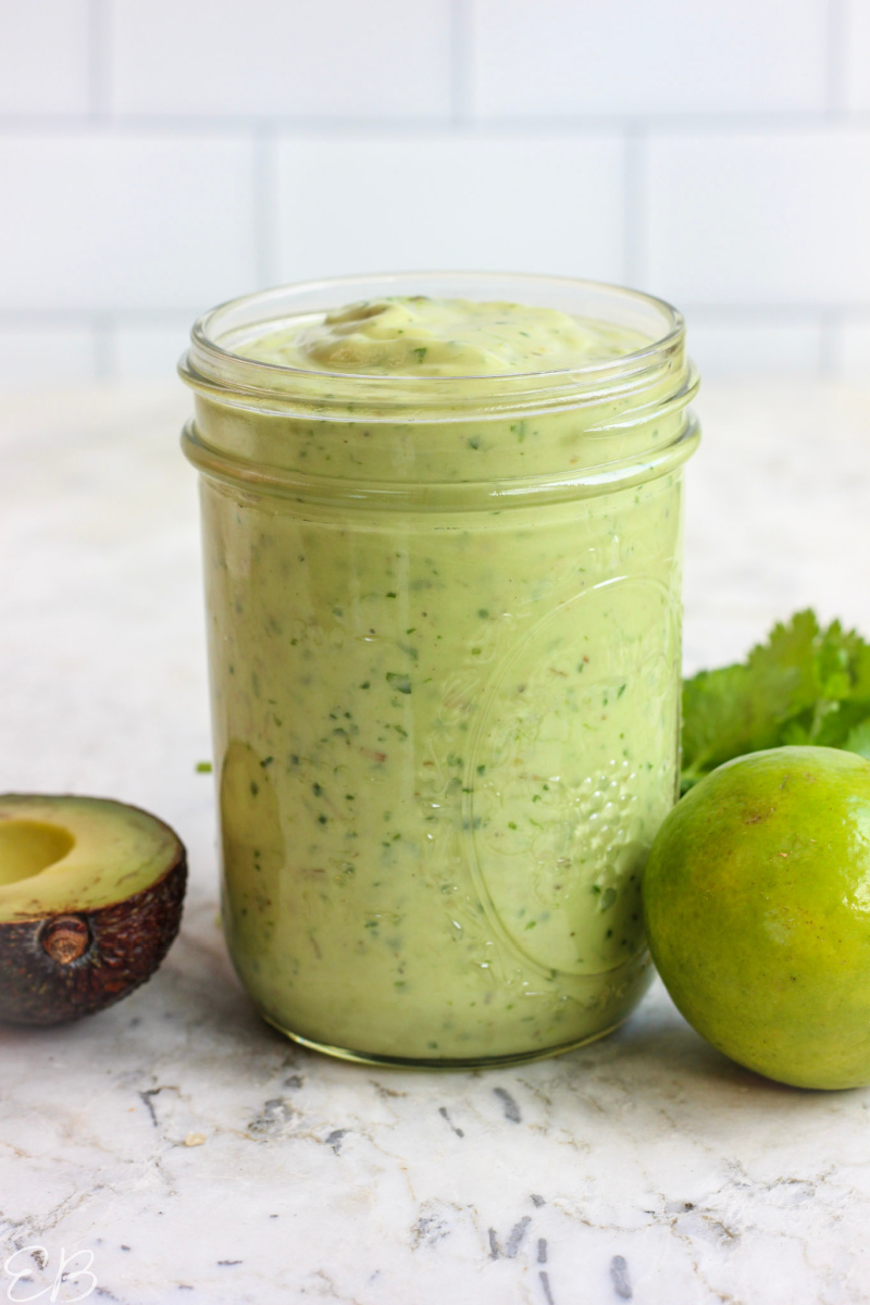 mason jar of cilantro lime ranch dressing with tile background